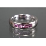 An 18ct. white gold heavy ring set five square-cut pink sapphires; size: M/N; weight 9.8gm.