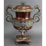 An early 19th century copper samovar with embossed foliate decoration, dolphin side handles, &