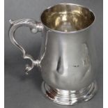 A George II silver baluster mug with acanthus scroll handle, & on raised circular foot, 5” high;