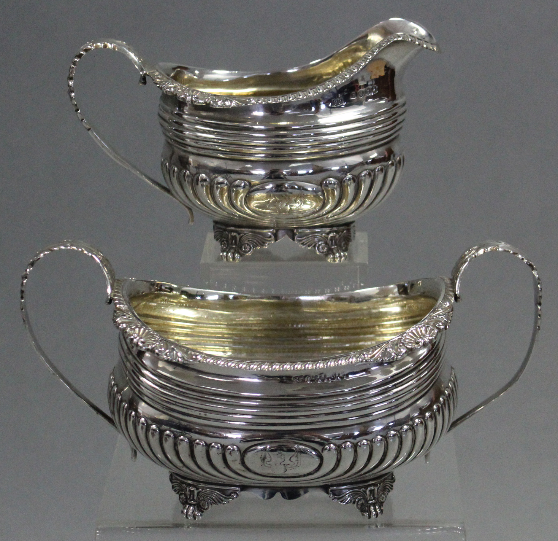 A George III silver sugar basin & matching milk jug of compressed oblong semi-fluted form, with