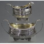 A George III silver sugar basin & matching milk jug of compressed oblong semi-fluted form, with