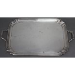 A George V silver rectangular two-handled tray with raised moulded border & re-entrant corners, 16¾”