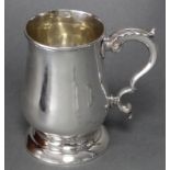 A George III silver baluster mug with acanthus scroll handle, & on raised circular foot, 5¾” high;