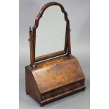 A Queen Anne style burr walnut & featherbanded swing dressing table mirror, the shaped mirror