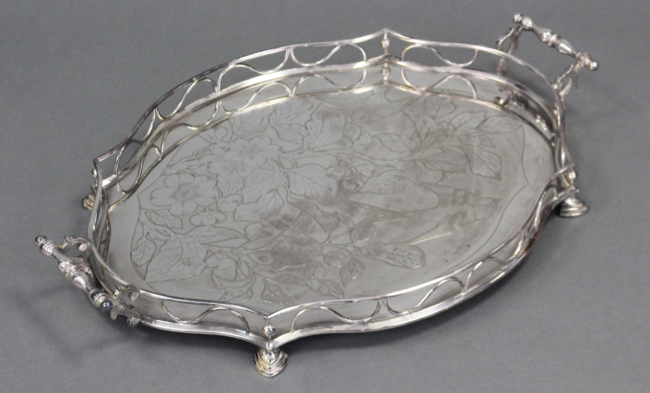 An Edwardian silver-plated shaped oval two-handled tray with embossed decoration of a bird amongst - Image 3 of 3