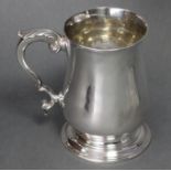 An early George III silver large baluster mug with acanthus scroll handle, & on raised circular