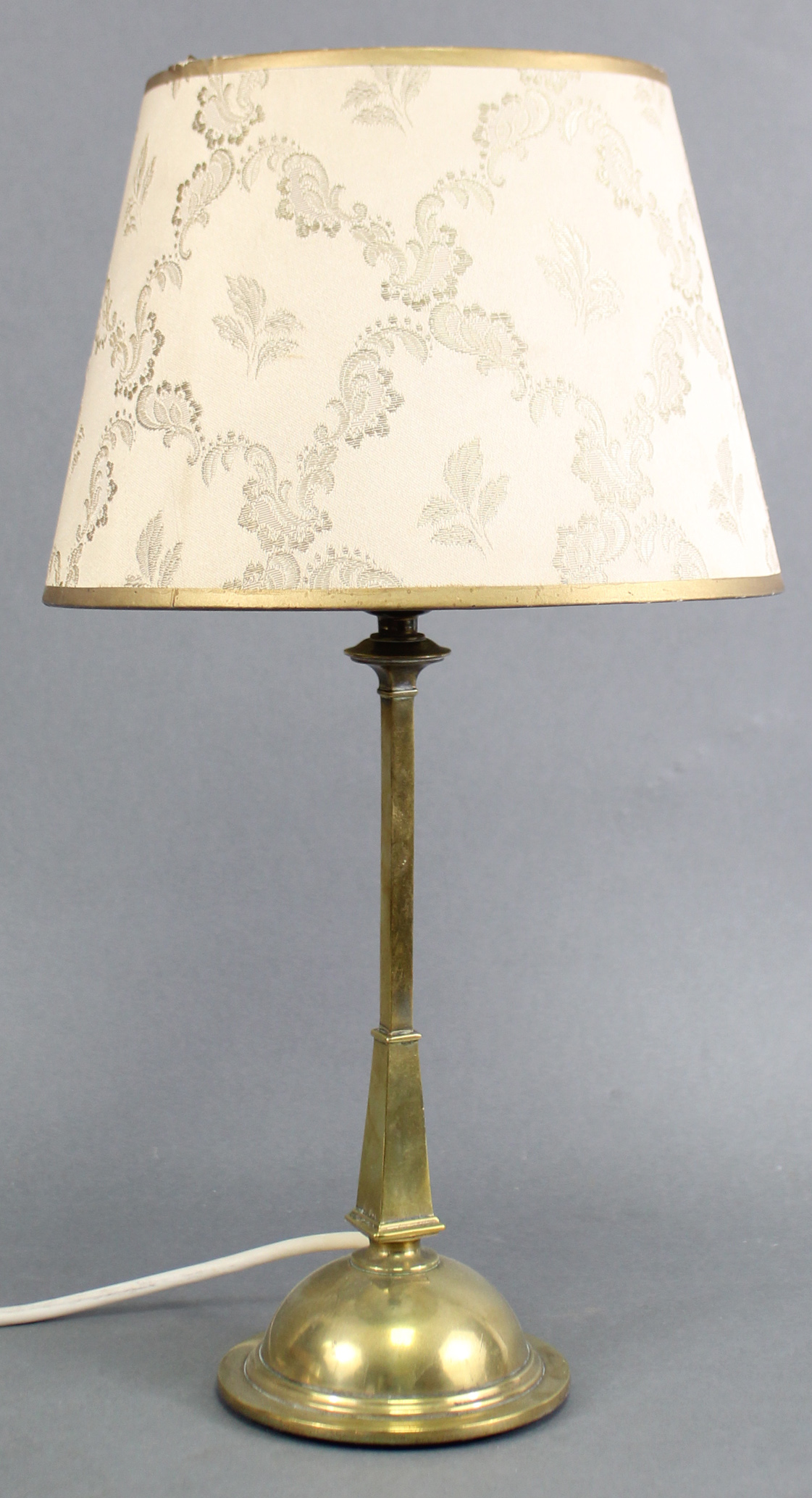 An Edwardian brass table lamp on slender square tapered column & domed circular base, stamped “Rd.