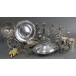 A meat carving stand; an oval tureen; three candelabra; glass preserve pot on plated stand; a