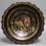 A Victorian papier maché shallow bowl, the centre painted with a scene of Napoleon in a room