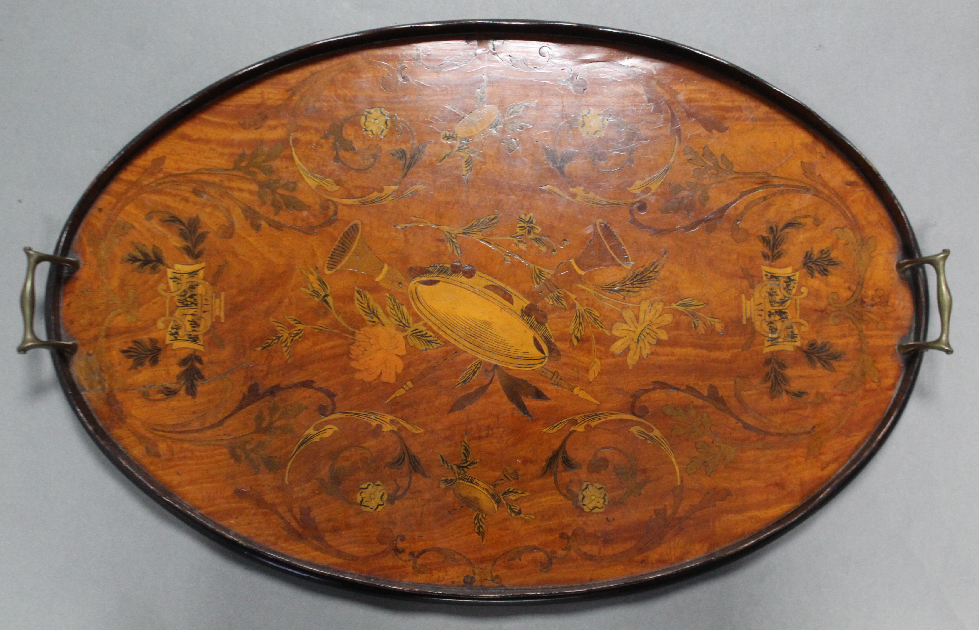 A 19th century mahogany oval tray with marquetry decoration of musical instruments & floral scrolls, - Image 2 of 2