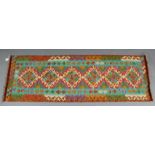 A Choli kelim vegetable-dye runner of rust, turquoise, & ivory ground with central row of six