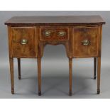 A George III inlaid-mahogany bow-front sideboard, fitted frieze drawer above a shaped ‘kneehole’