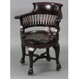A late 19th century mahogany swivel office chair with curved rail-back, circular hard seat, & on