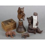 A Black Forest carved wood seated bear holding a thermometer, 5” high; a ditto table bell, the