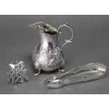 A Victorian silver baluster cream jug in the mid-18th century style, with embossed floral decoration