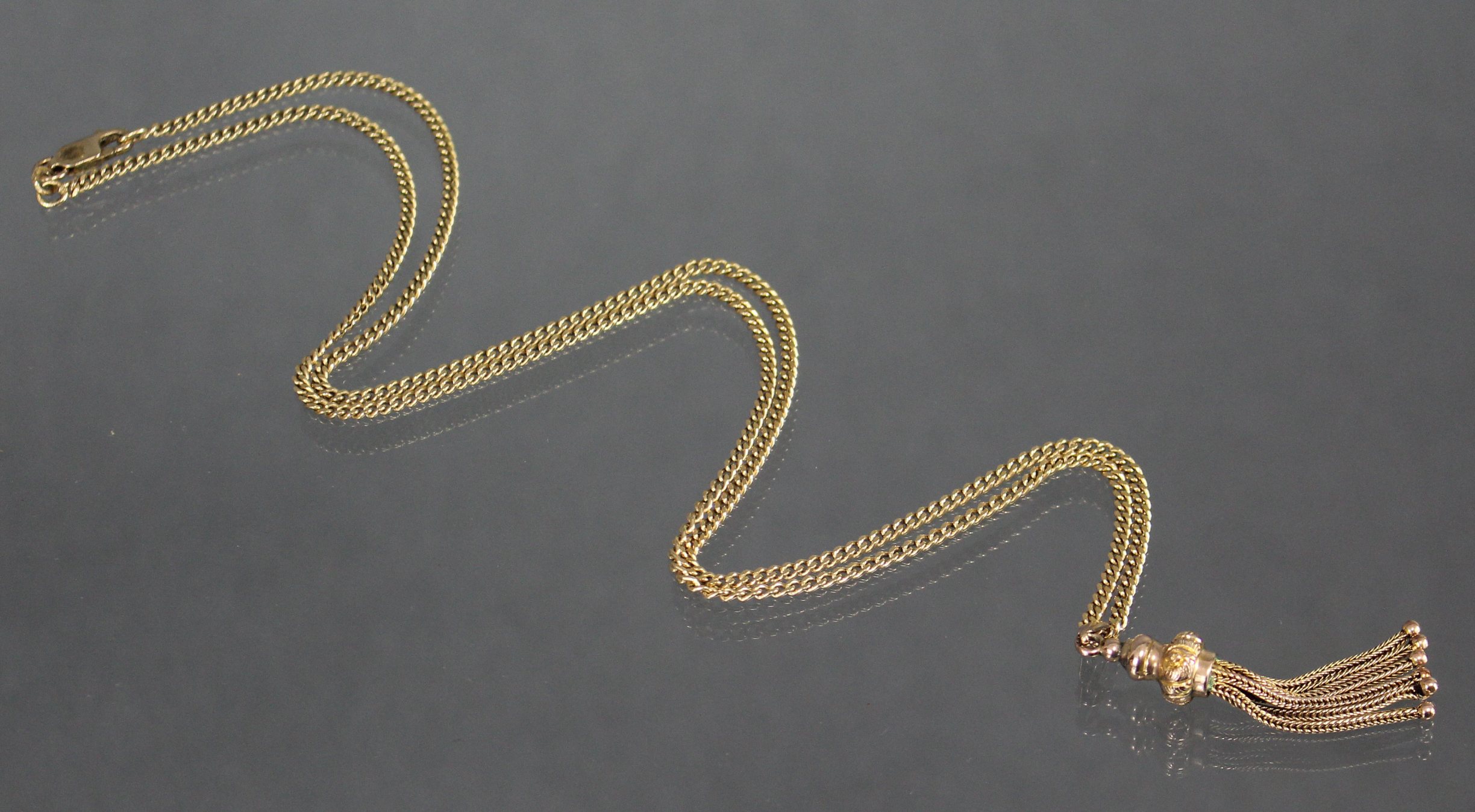 A yellow metal chain necklace of flattened curb links, marked “750”, 24” long (13.4gm); with gilt- - Image 2 of 3