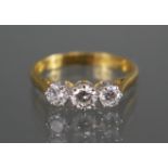 An 18ct. gold ring set three graduated diamonds, the centre stone approx. 0.3 carat, the smaller