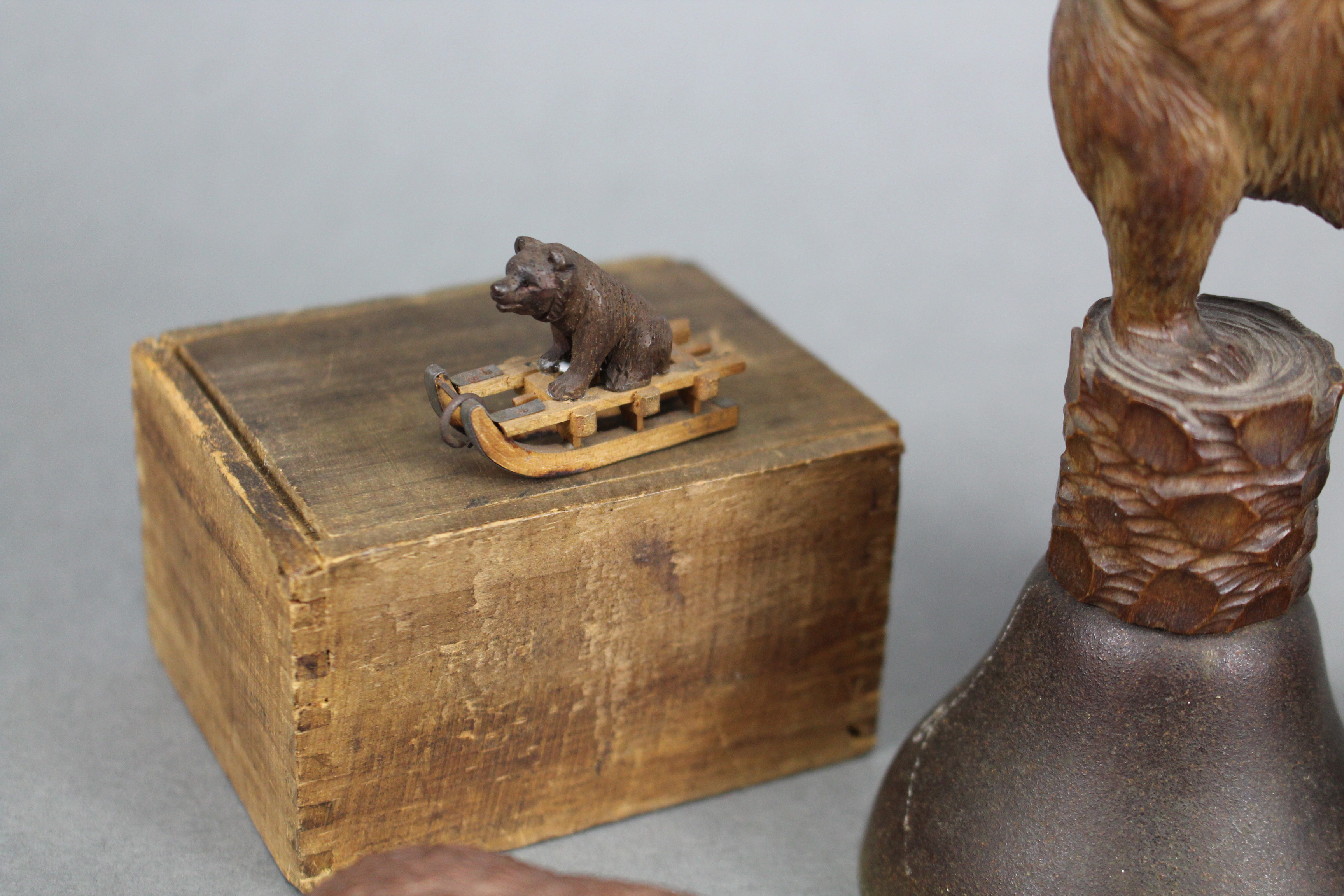 A Black Forest carved wood seated bear holding a thermometer, 5” high; a ditto table bell, the - Image 2 of 2