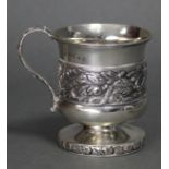 A George III silver small mug with embossed band of flowers & foliage, acanthus scroll handle, &