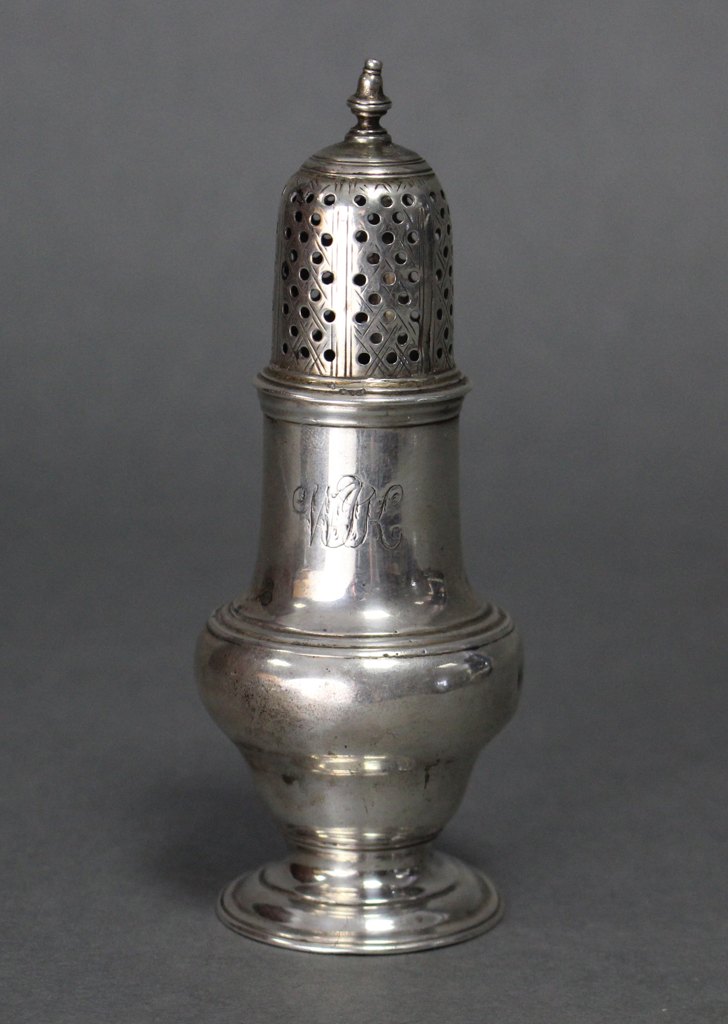 An early George III silver pepper pot with tall domed & pierced pull-off cover, the lower part of