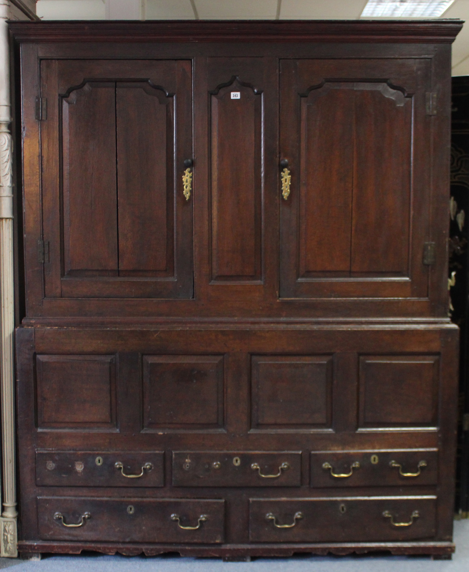 A LATE 17th/early 18th century OAK PRESS CUPBOARD, the upper part with moulded cornice, fitted two