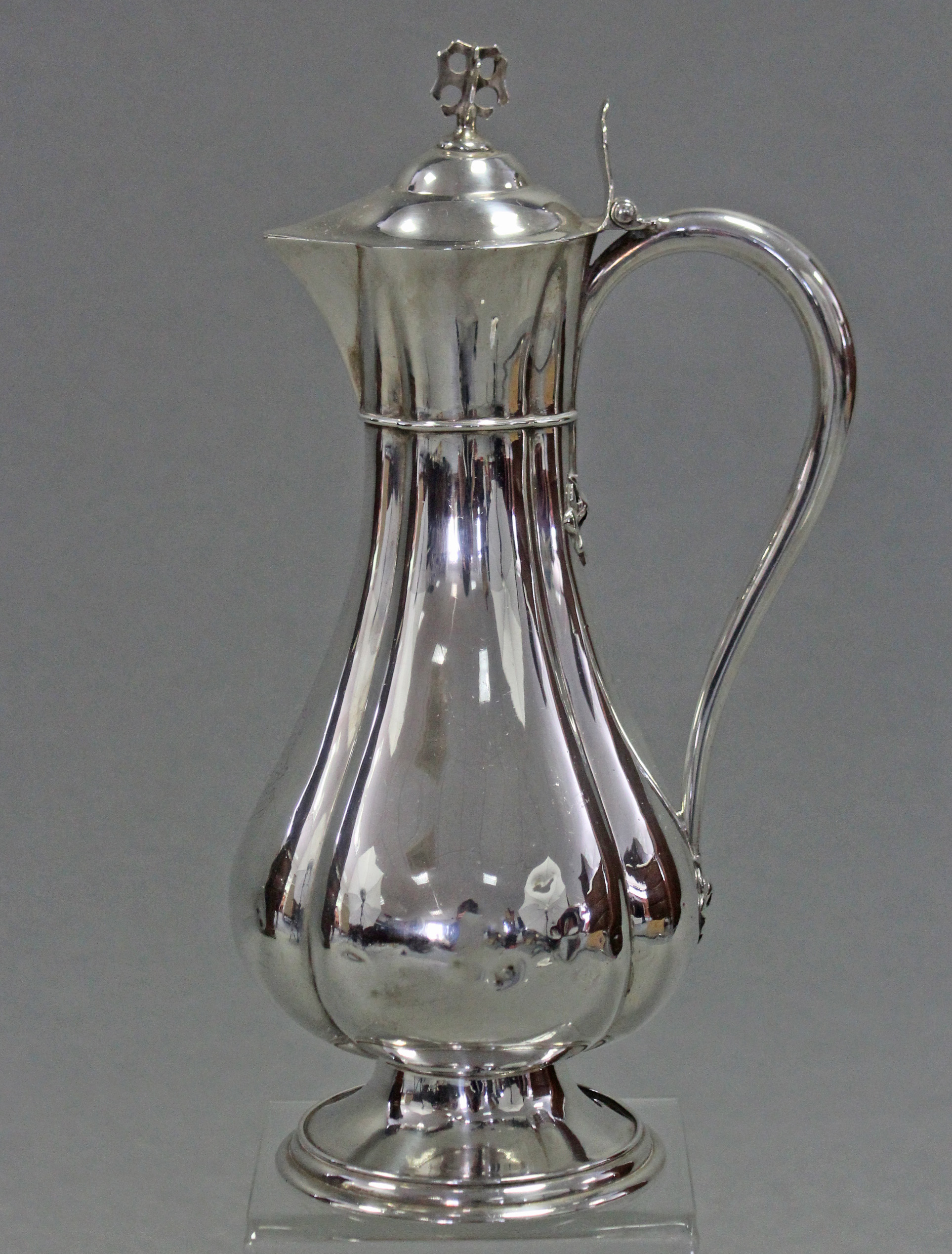 A Victorian silver communion wine flagon of fluted baluster form, with pierced finial & shaped