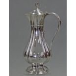 A Victorian silver communion wine flagon of fluted baluster form, with pierced finial & shaped