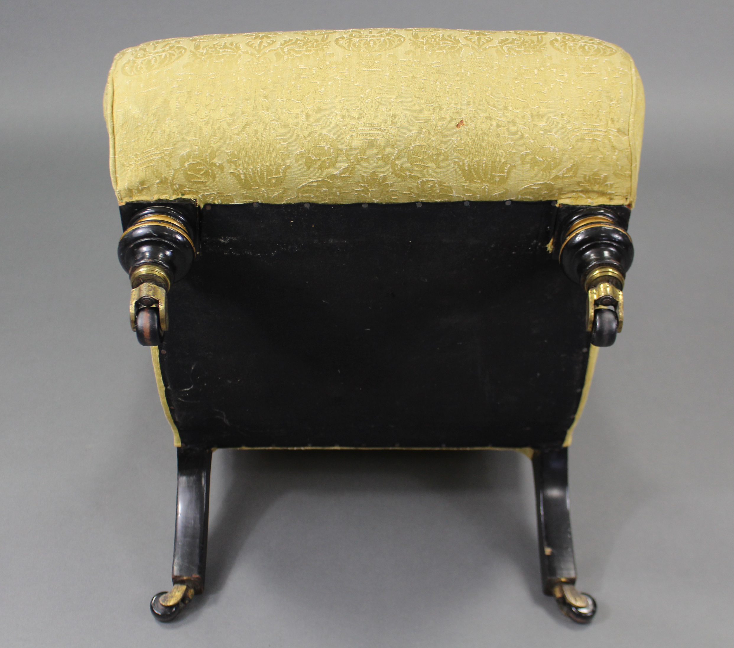 A Victorian nursing chair of scroll shape, upholstered yellow silk with repeating floral motif, on - Image 5 of 5