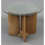 An Art Deco light oak occasional table on blade-shaped supports, & with part-mirrored circular glass