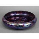 A 1930’s Burslem lusterware shallow bowl of mottled deep purple ground, 11½” diam.