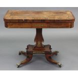A regency rosewood & brass-inlaid card table, the rectangular fold-over top with wide crossbanding