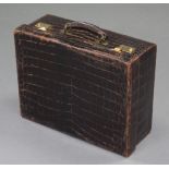A brown crocodile skin suitcase with gilt-brass twin locks, retailed by Edwards & Sons, Regent