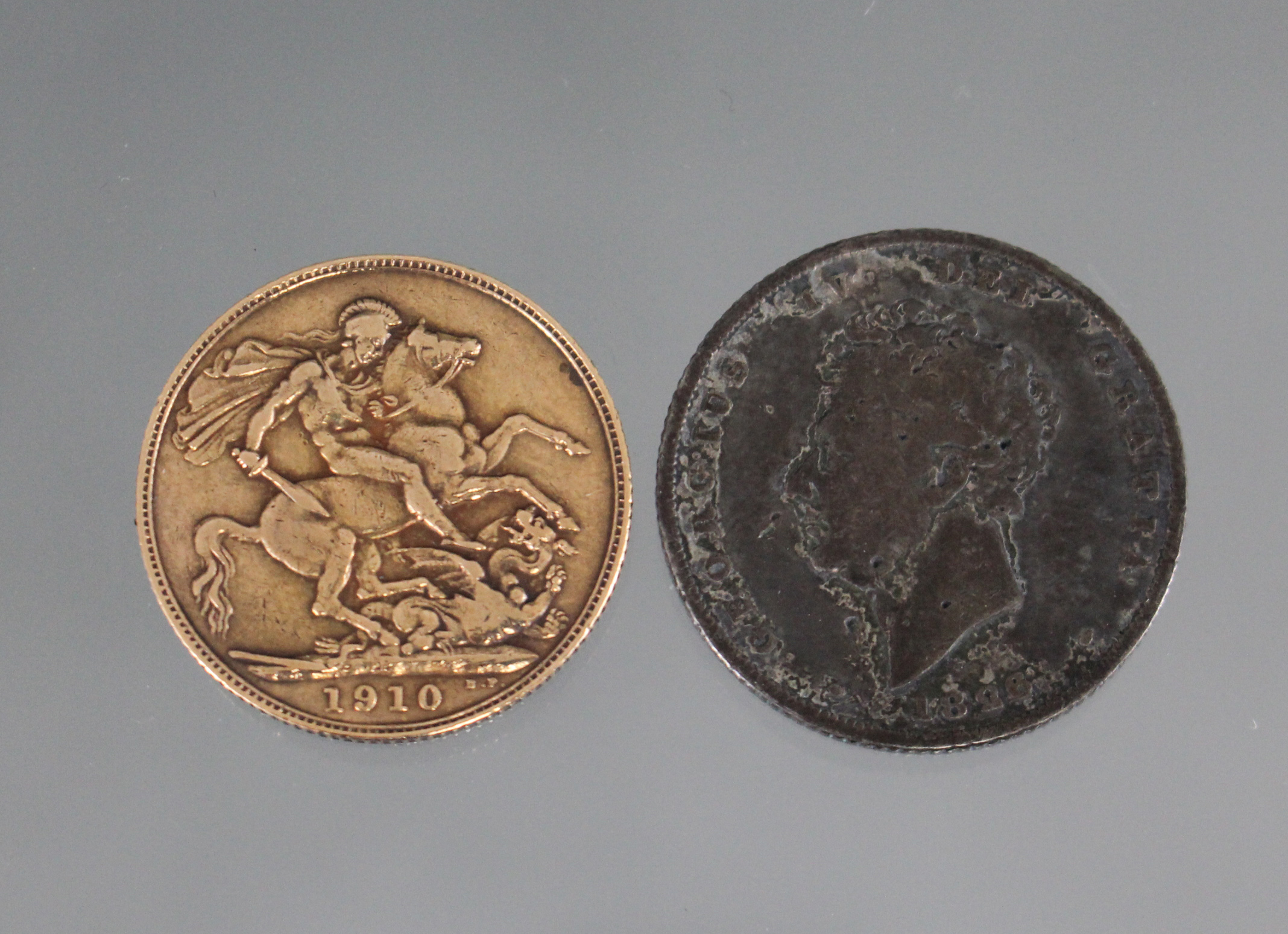 An Edward VII sovereign, Perth mint, 1910; together with a George IV shilling, 1826.