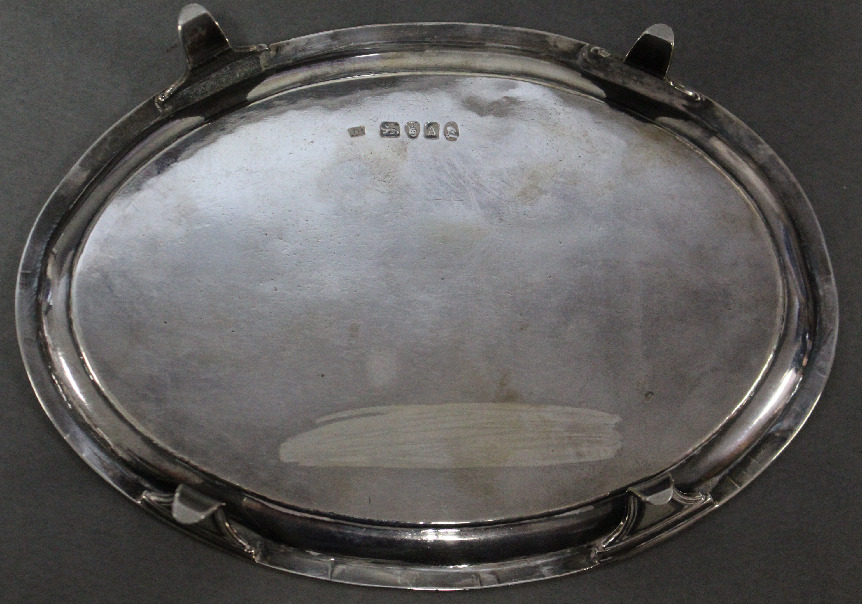 A George III silver oval teapot stand with pricked borders, engraved monogram to centre, & on four - Image 3 of 3