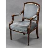 A Louis XVI style carved beech frame fauteuil with padded square back, open arms, & on turned &