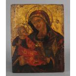 A Greek Icon depicting the Mother of God, her maphorion highlighted with gilt, supporting the infant
