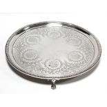 A Victorian silver waiter with engraved leaf-scroll decoration within a beaded rim, on three