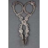 A pair of Victorian cast silver scissor-action sugar nips of leafy tendril design, 4½” long;