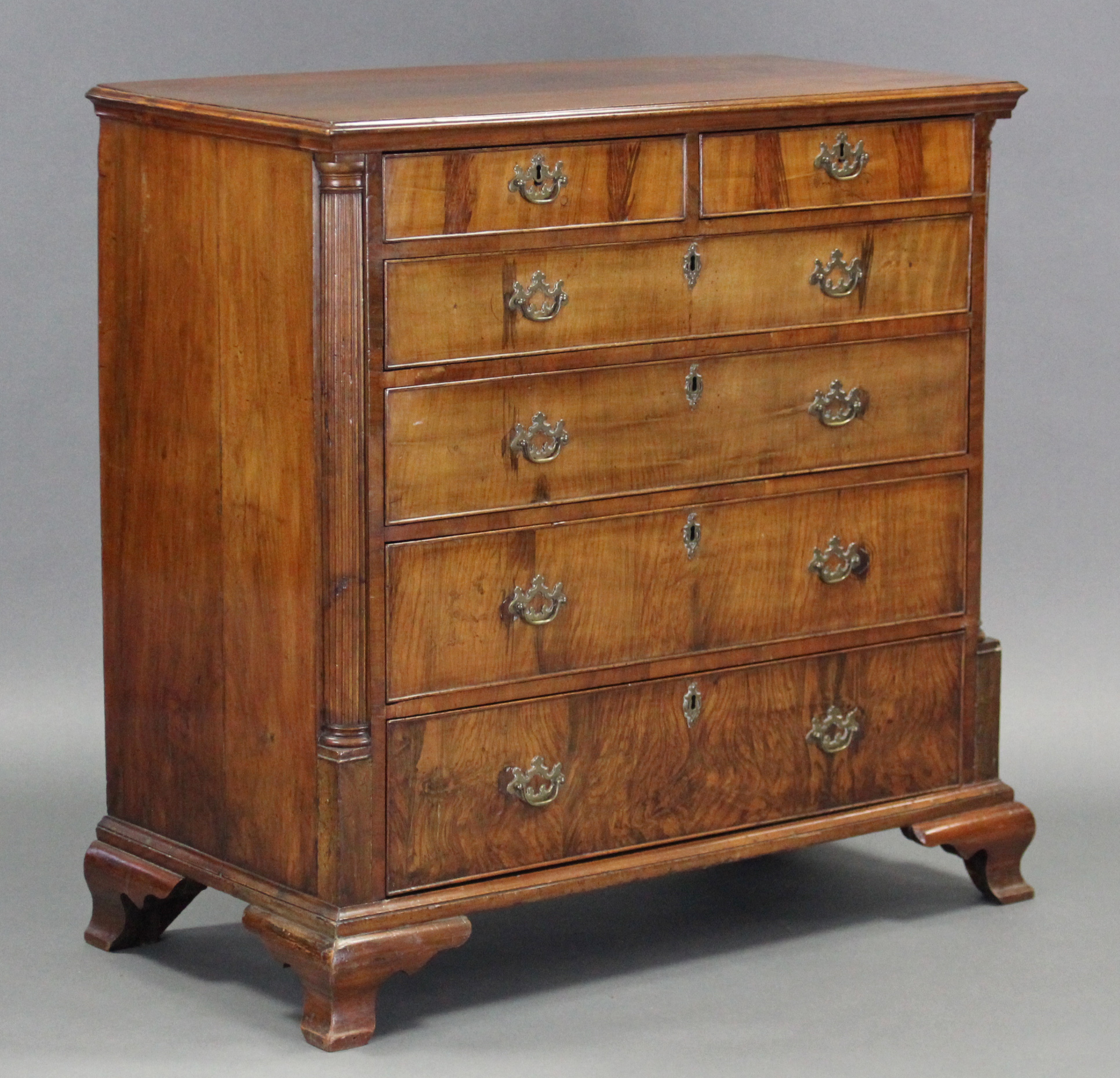 A MID-18th century FIGURED WALNUT CHEST, fitted two short & four long graduated drawers with