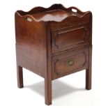 A late 18th century mahogany tray-top bedside commode enclosed by panel door; 20½” wide.