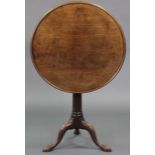 A late 18th century mahogany tripod table, the circular top with moulded raised edge, on gun-