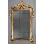 A George II-style rectangular wall mirror in gilt frame with foliate crest & husk-swags; 24” x 42”.