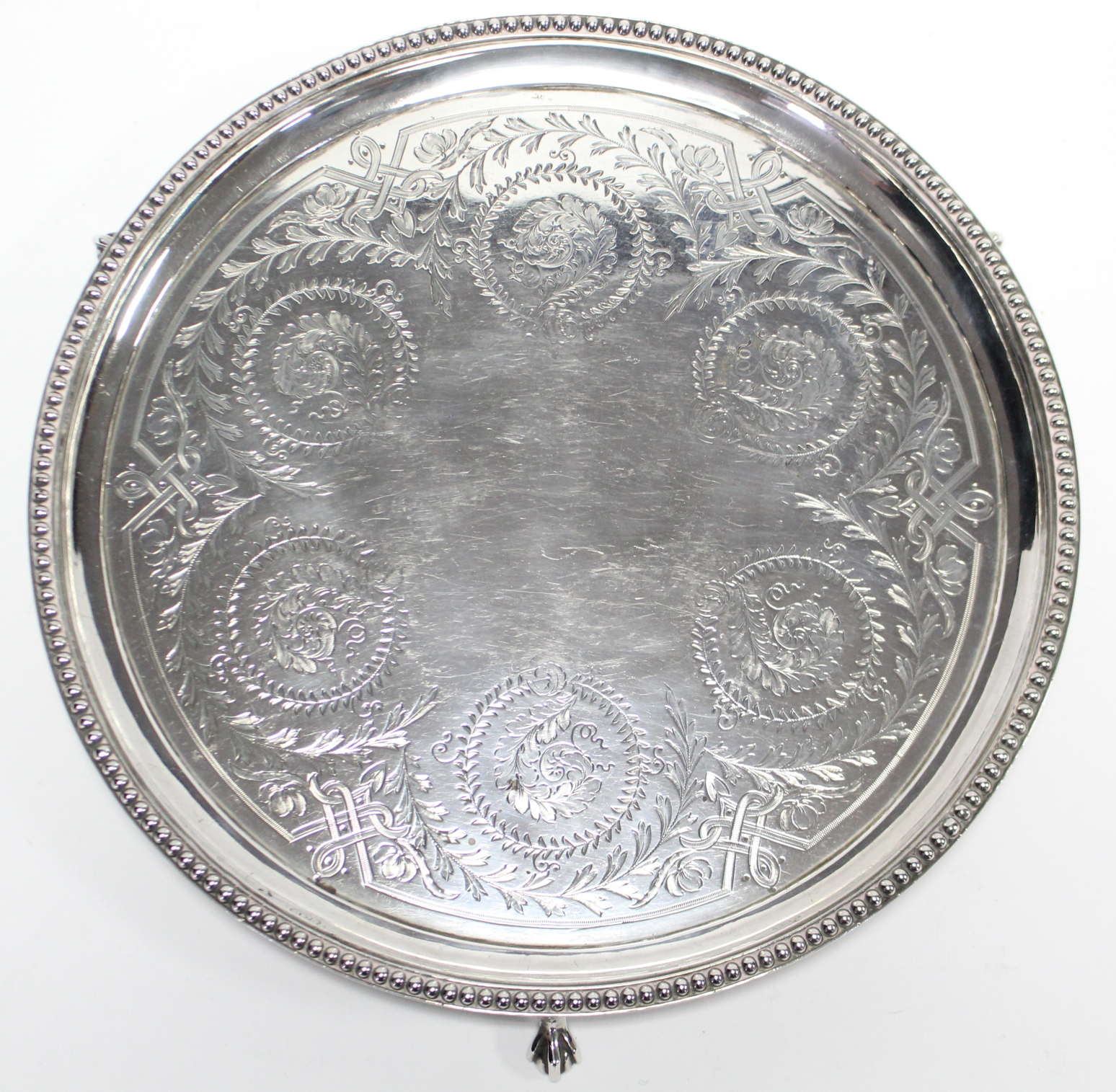 A Victorian silver waiter with engraved leaf-scroll decoration within a beaded rim, on three - Image 2 of 4