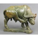 T. MAISIRI, a carved hardstone sculpture of a buffalo scratching its ear with its rear right leg, on