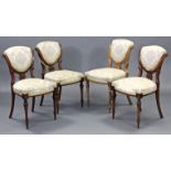 A set of four Victorian carved & inlaid walnut salon chairs, the padded seats & shield-shaped