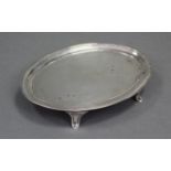 A George III silver oval teapot stand with pricked borders, engraved monogram to centre, & on four