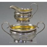 A George IV silver two-handled sugar bowl & matching milk jug, both of compressed oval shape, with