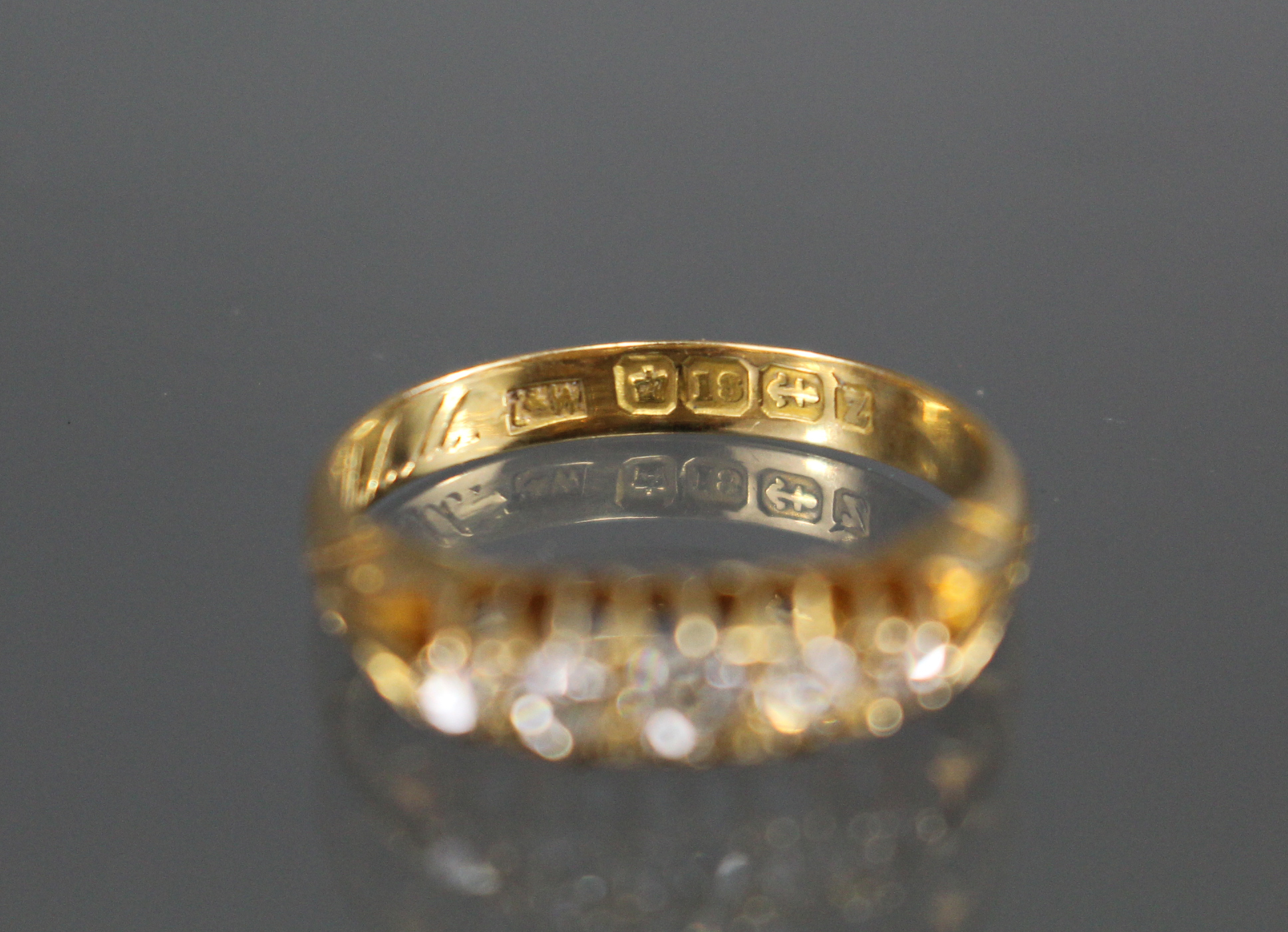 A late Victorian 18ct. gold ring set five small graduated diamonds, Birmingham hallmarks for 1899; - Image 3 of 4