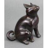 A bronze model of a seated cat, its head turned upwards; 5¾” high.