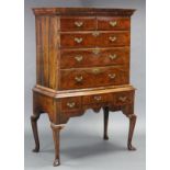 A GEORGE II FIGURED WALNUT CHEST-ON-STAND, with moulded cornice, fitted two short & three long